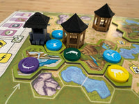 Ark Nova animal tokens close up with kiosks